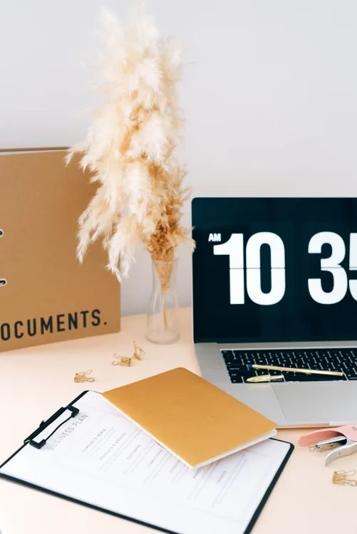 Laptop, notes and documents on a workspace