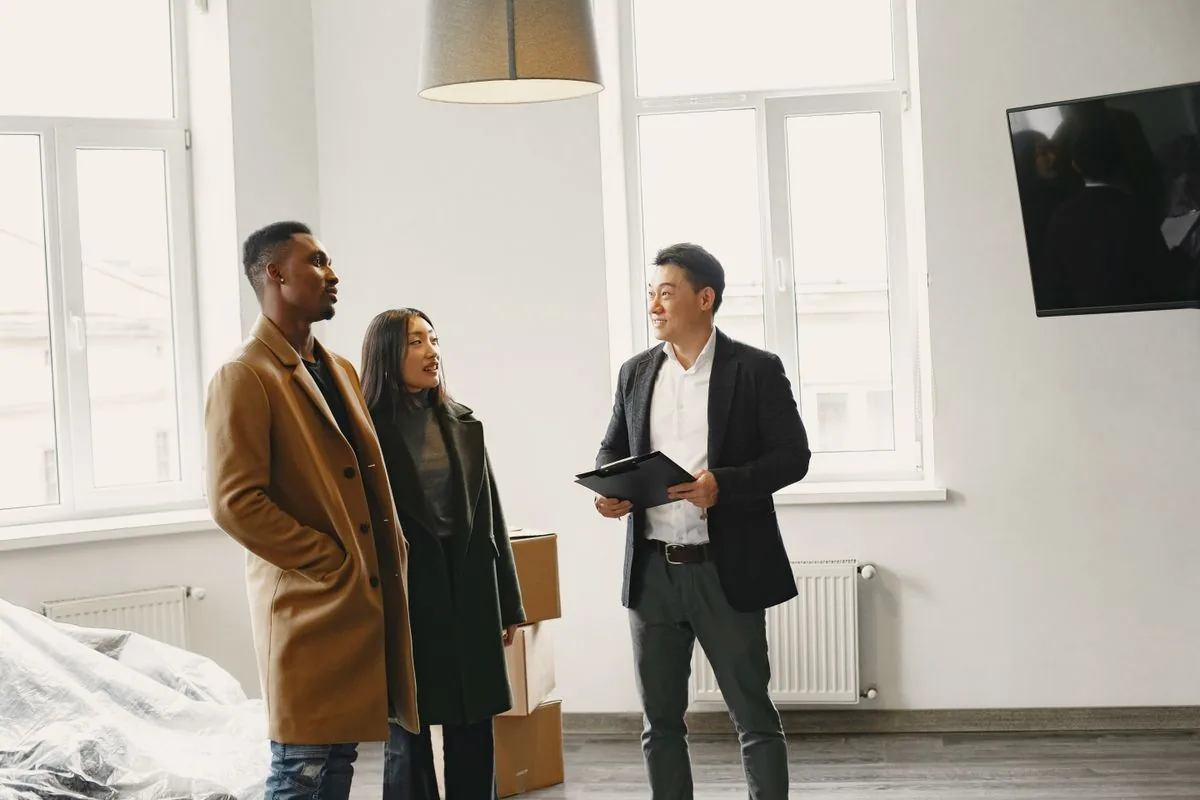 A property adviser talking with two clients in a home