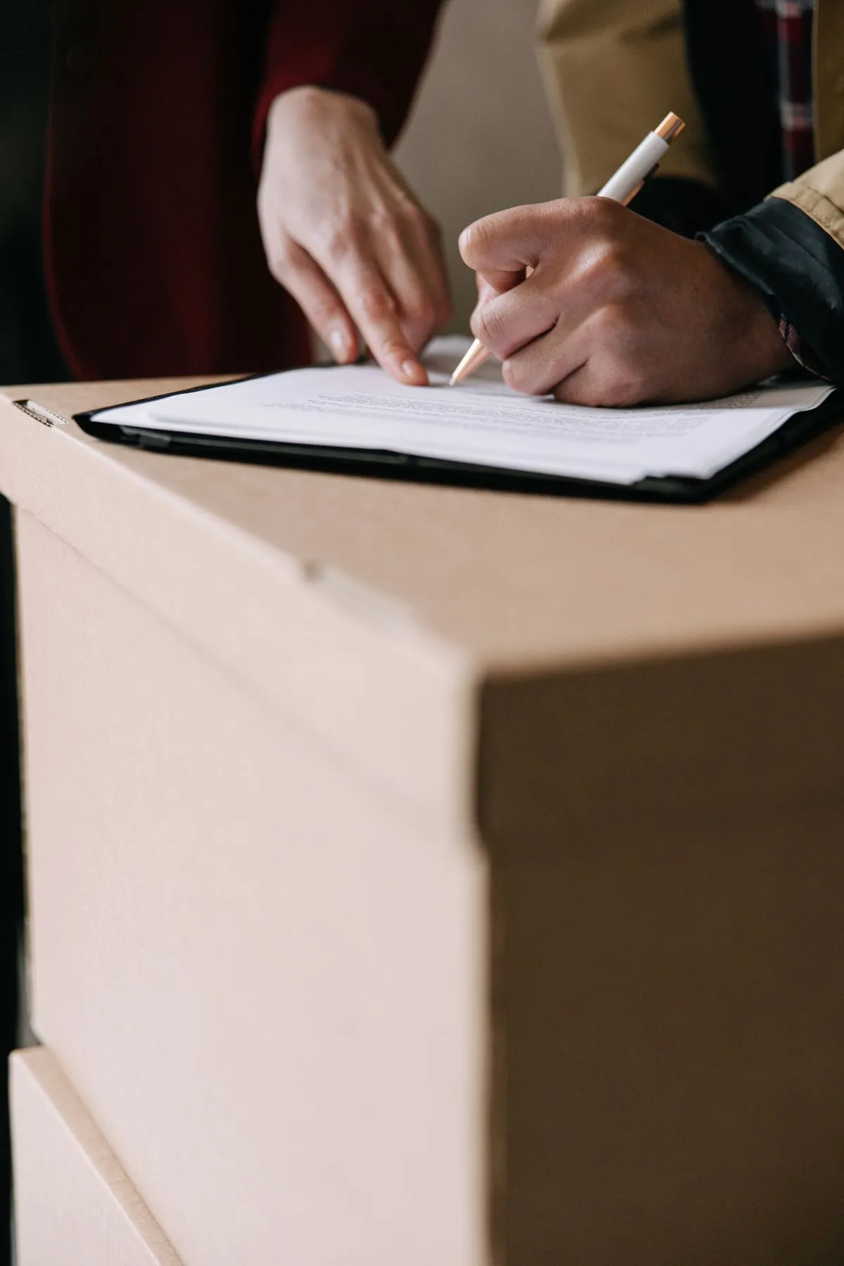 A person reviewing and signing an agreement at home