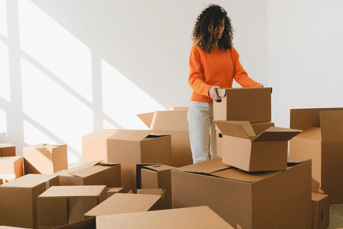 A woman packing boxes before moving out
