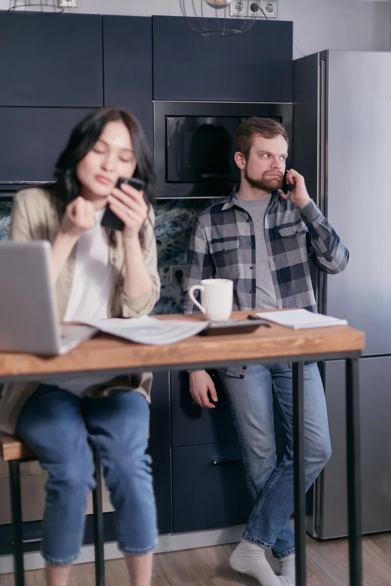 A couple discussing household bills at a table
