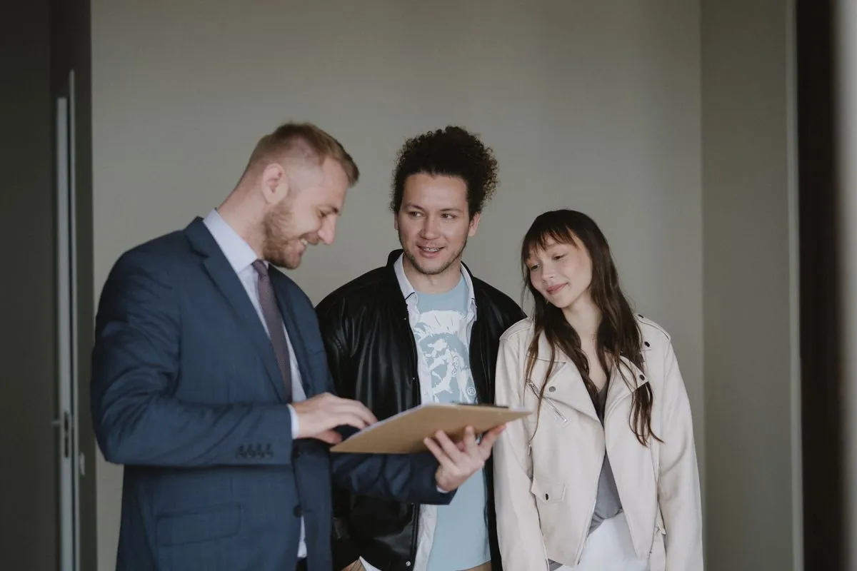 A couple discussing property paperwork with an agent