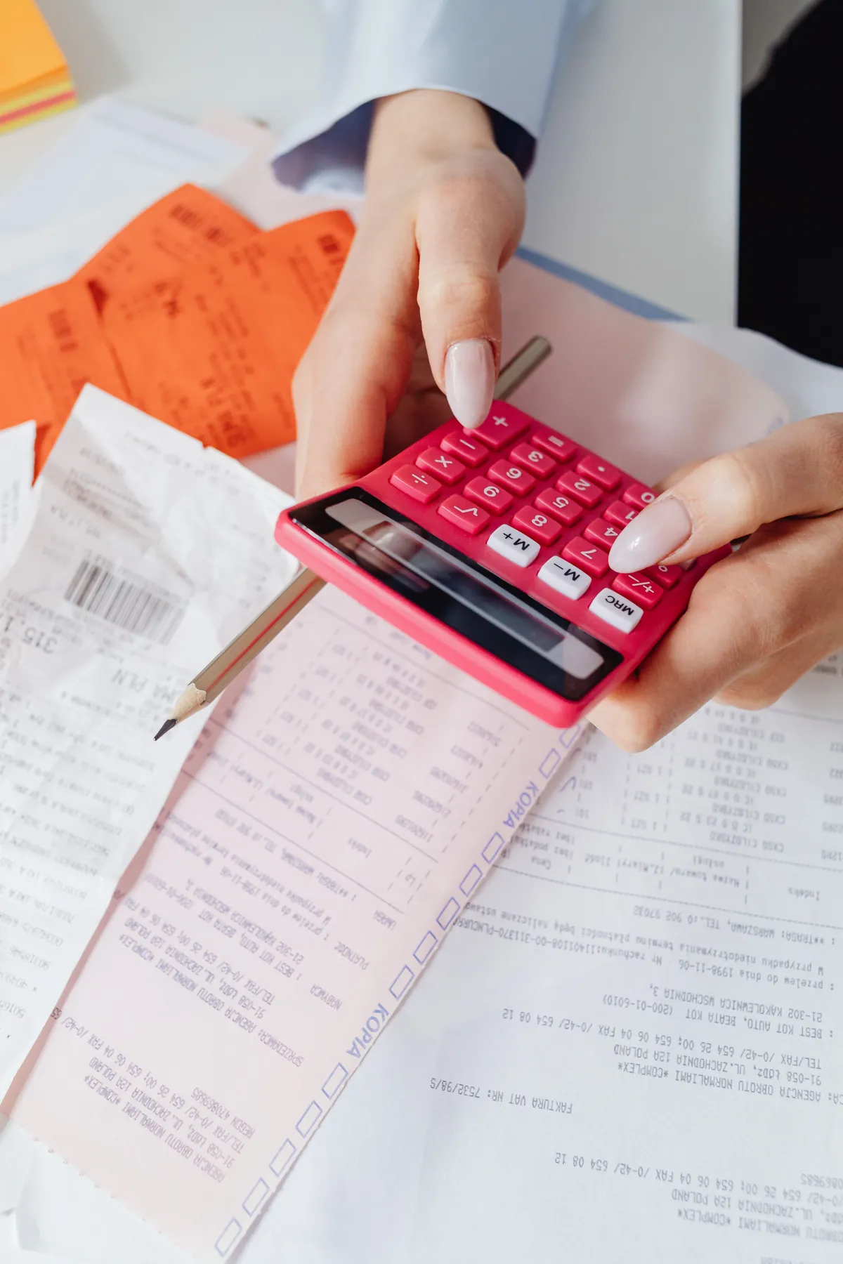 A person calculating costs with financial documents