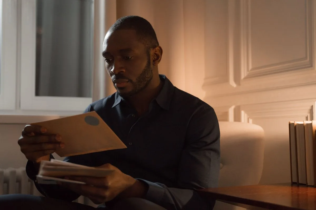 A man reading a letter at home