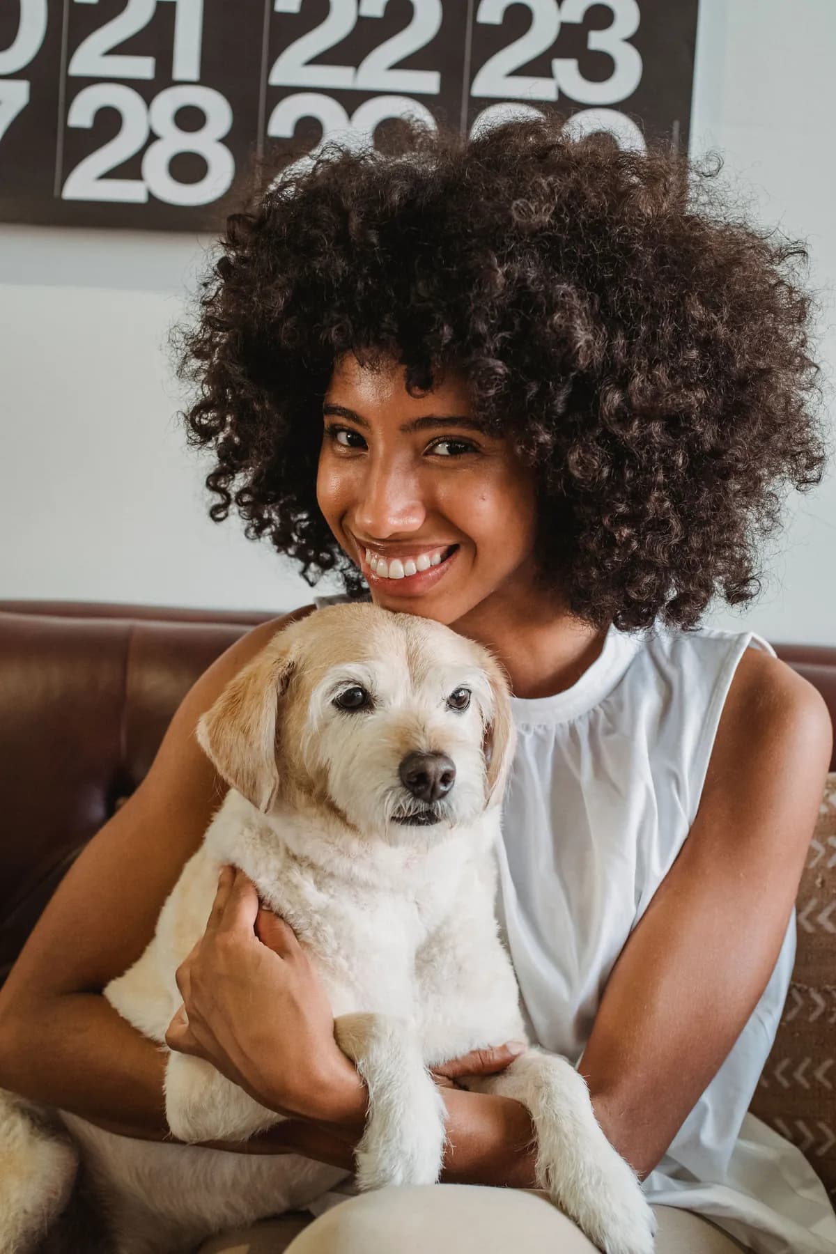 A renter relaxing on a sofa with a pet dog