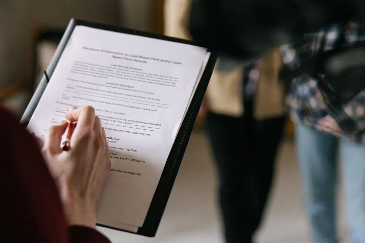 A person reviewing property paperwork on a clipboard