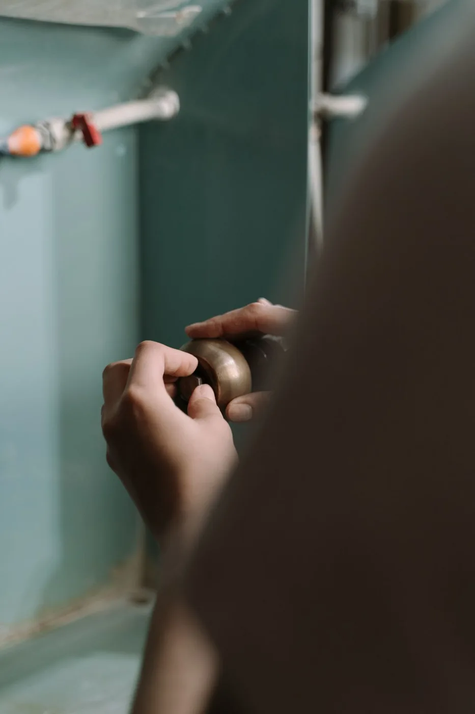 Hands adjusting a door handle during a household repair