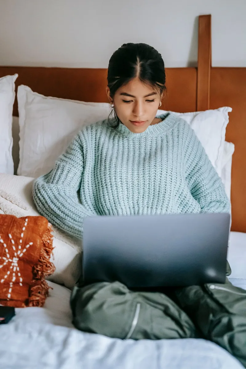 A woman using a laptop at home