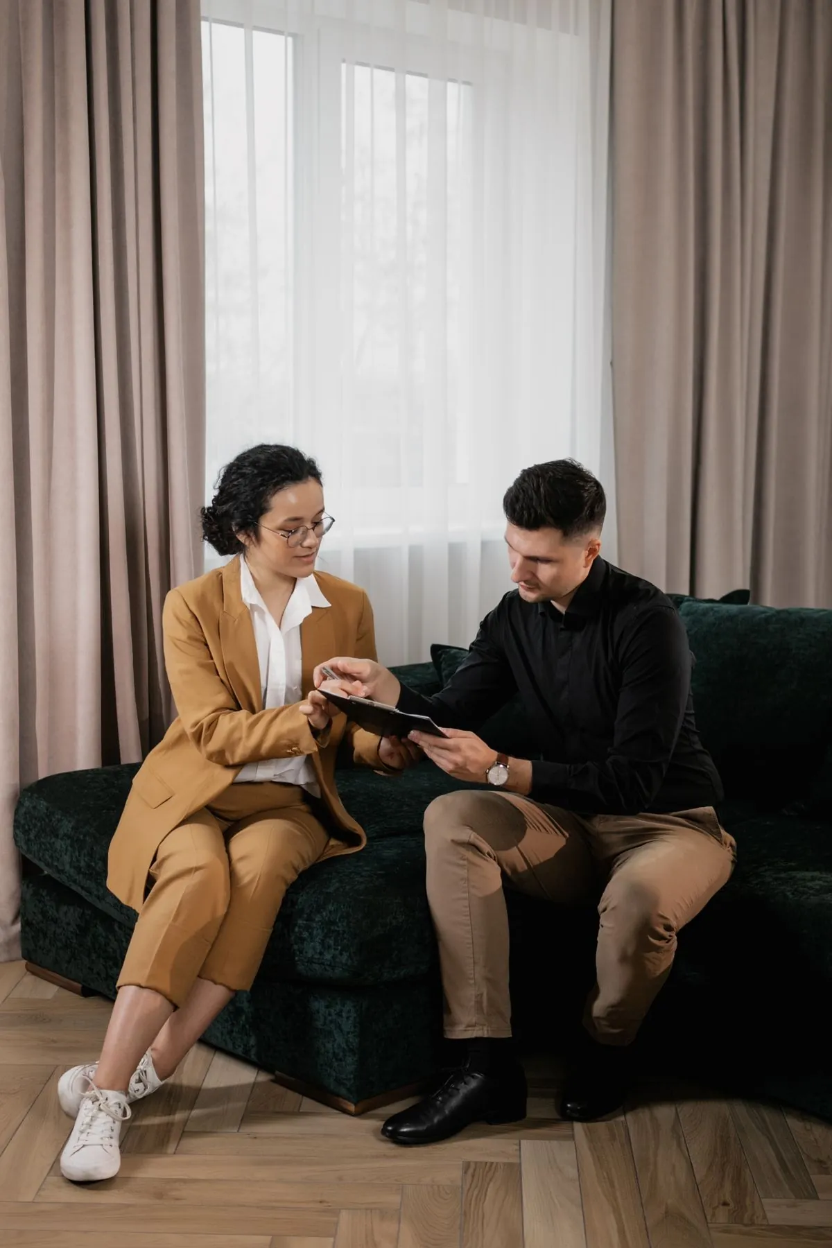 An agent explaining application paperwork to a client